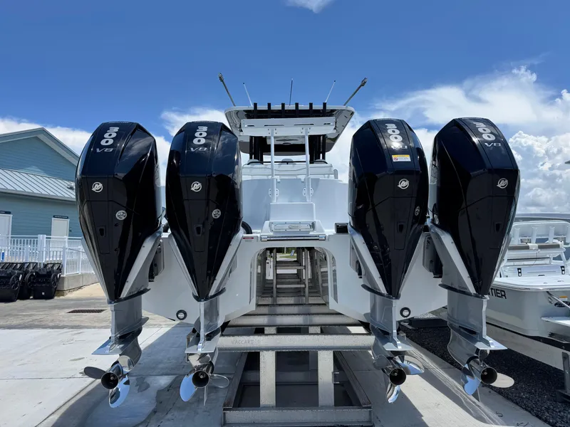 Slide: The Image of 2026 Invincible 38 Catamaran with four powerful V8 engines, docked under a clear sky. - 4