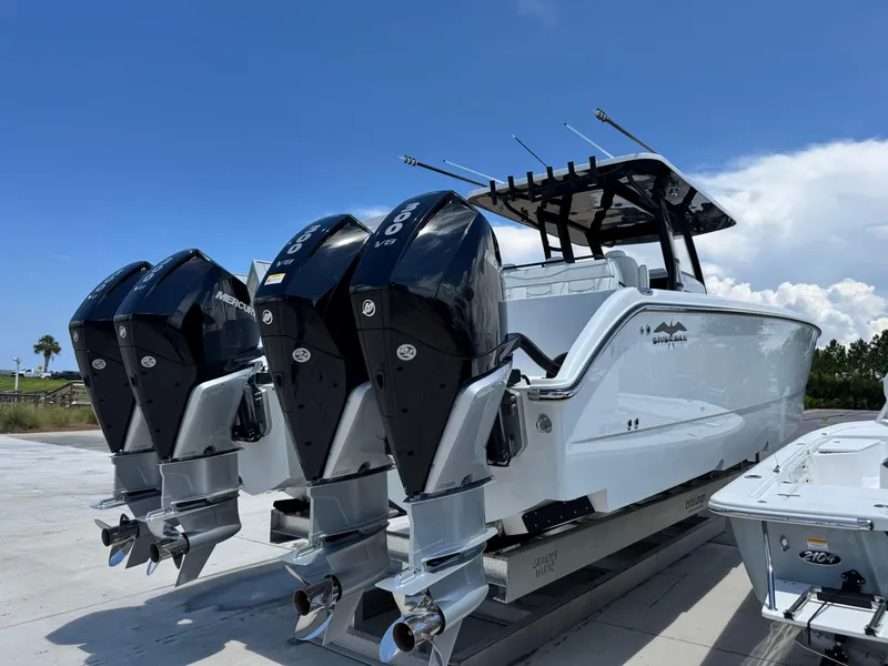Slide: The Image of 2026 Invincible 38 Catamaran with triple Mercury outboard engines, docked under a clear blue sky. - 5
