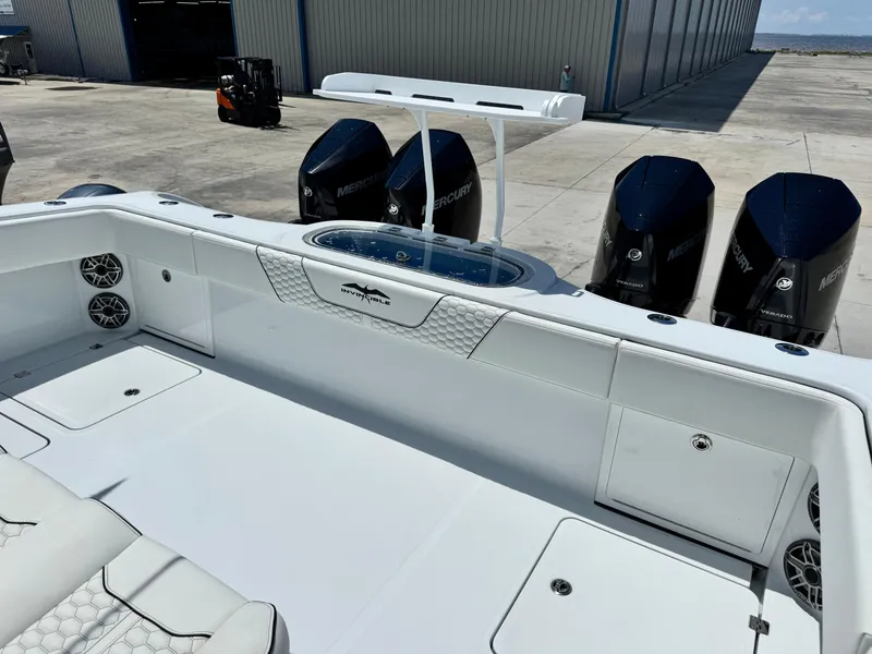 Slide: The Image of 2026 Invincible 38 Catamaran with Mercury engines, docked at a marina. - 8