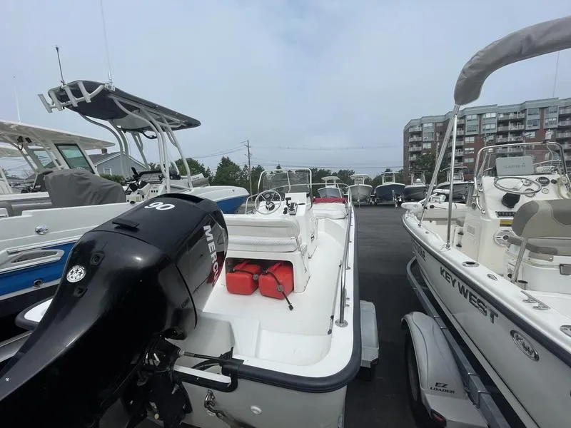 Slide: The Image of 2008 Boston Whaler 170 Montauk boat with Mercury engine, docked among other boats. - 3