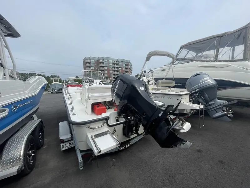 Slide: The Image of 2008 Boston Whaler 170 Montauk boat with outboard motor in a marina. - 7