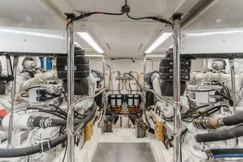 Slide: The Image of Engine room of 2001 Mikelson 61 Yachtfisher, showcasing dual engines and mechanical systems. - 103