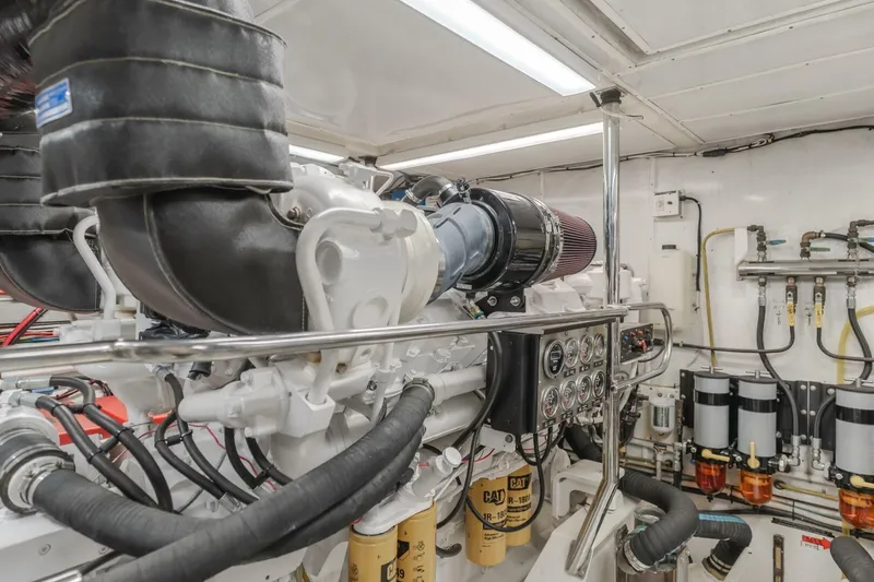 Slide: The Image of Engine room of 2001 Mikelson 61 Yachtfisher, showcasing detailed mechanical components. - 104