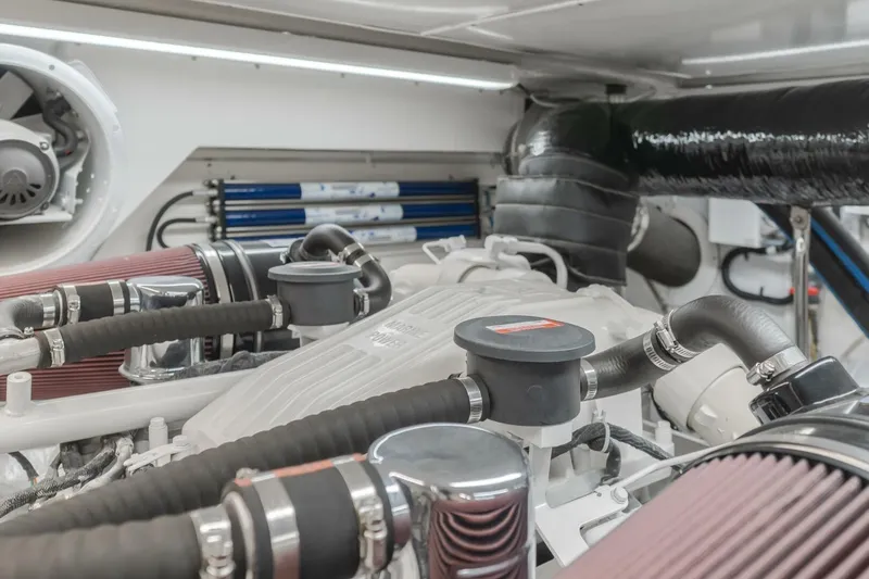 Slide: The Image of Engine room of 2001 Mikelson 61 Yachtfisher, showcasing detailed mechanical components. - 105