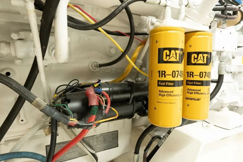 Slide: The Image of Engine compartment of 2001 Mikelson 61 Yachtfisher with CAT fuel filters and wiring. - 109