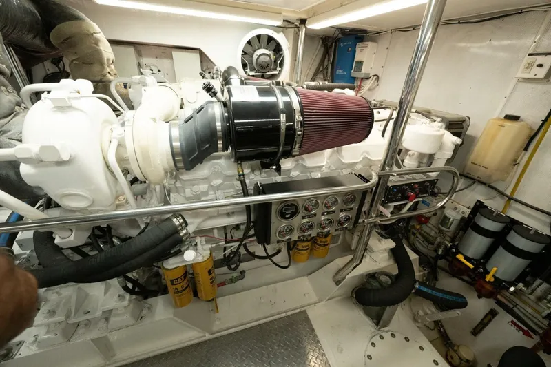 Slide: The Image of Engine room of a 2001 Mikelson 61 Yachtfisher, showcasing detailed mechanical components. - 113