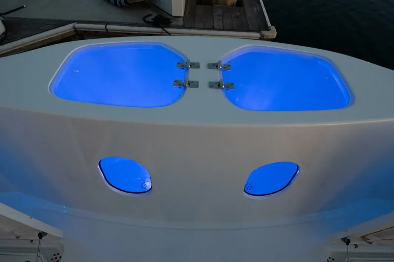 Slide: The Image of Livewell compartments with blue lighting on a 2001 Mikelson 61 Yachtfisher. - 115