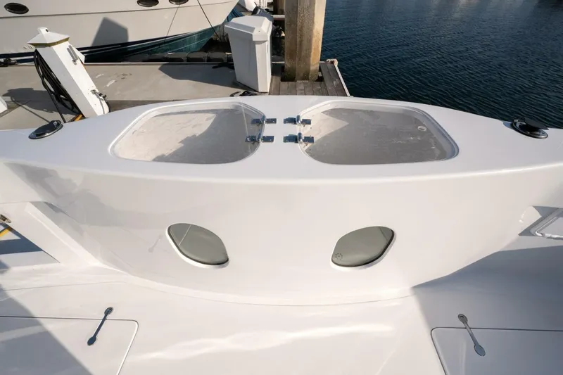 Slide: The Image of 2001 Mikelson 61 Yachtfisher deck with storage compartments and ocean view. - 116