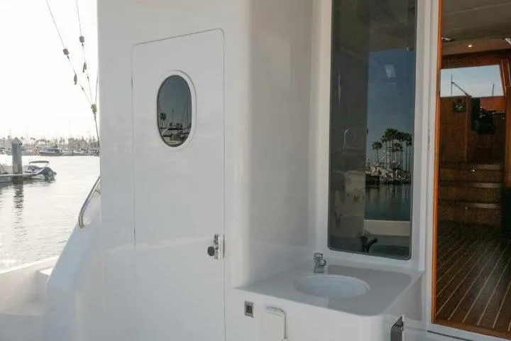 Slide: The Image of 2001 Mikelson 61 Yachtfisher exterior with sink and door, docked at marina. - 118
