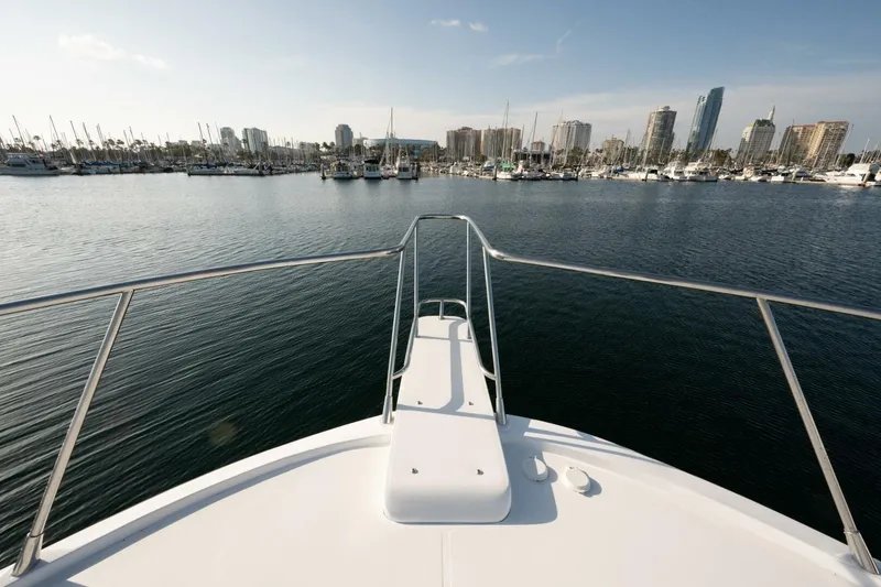 Slide: The Image of Bow view of 2001 Mikelson 61 Yachtfisher in a marina with city skyline. - 120