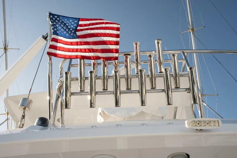 Slide: The Image of American flag on 2001 Mikelson 61 Yachtfisher, with clear blue sky background. - 123