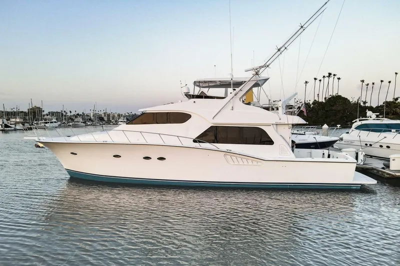 Slide: The Image of 2001 Mikelson 61 Yachtfisher in marina, side view, calm waters, clear sky. - 124