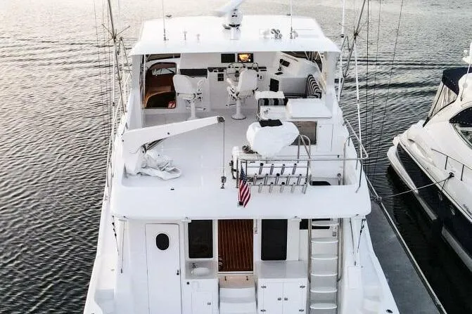 Slide: The Image of 2001 Mikelson 61 Yachtfisher, aerial view, docked, showcasing spacious deck and seating area. - 125