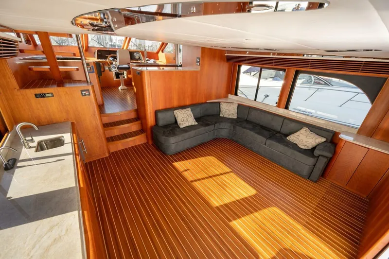 Slide: The Image of Luxurious interior of 2001 Mikelson 61 Yachtfisher with wood flooring and plush seating. - 62