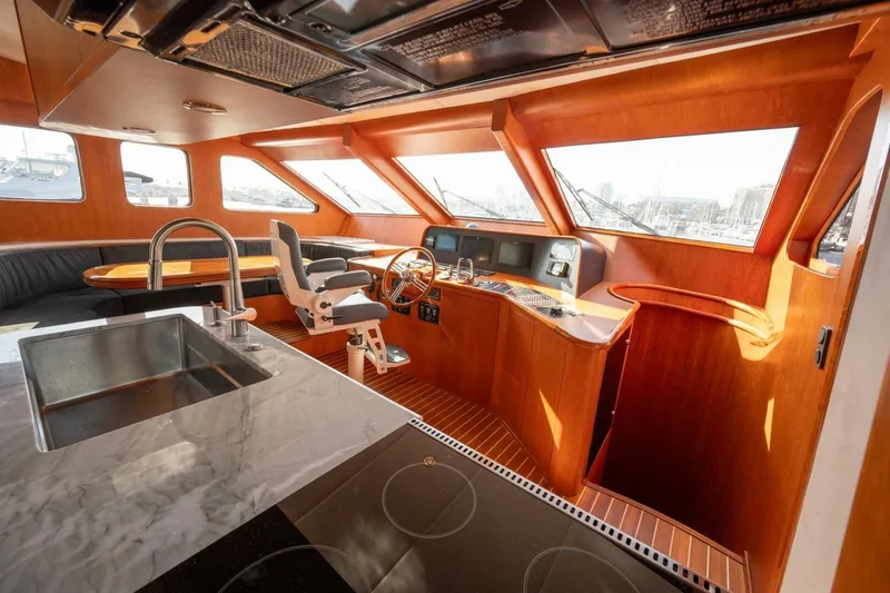 Slide: The Image of Luxurious interior of 2001 Mikelson 61 Yachtfisher with modern helm and kitchen area. - 66