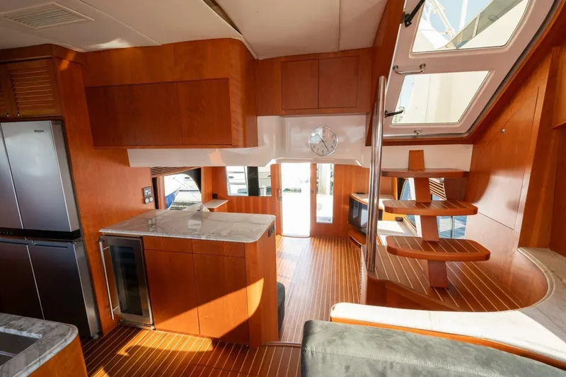 Slide: The Image of Luxurious interior of 2001 Mikelson 61 Yachtfisher with wooden finishes and modern kitchen. - 73
