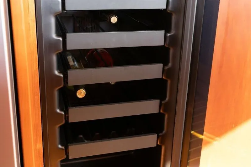 Slide: The Image of Wine cooler with bottles inside a 2001 Mikelson 61 Yachtfisher. - 75