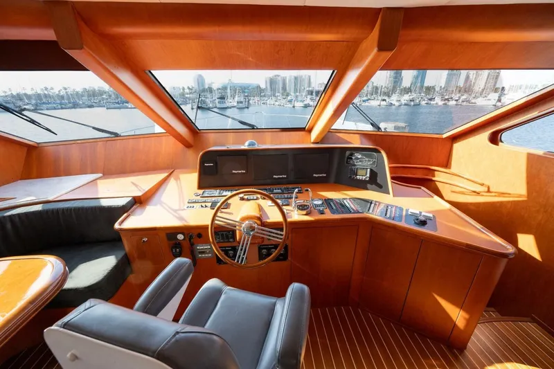 Slide: The Image of Interior view of 2001 Mikelson 61 Yachtfisher helm with panoramic windows and wooden finish. - 77