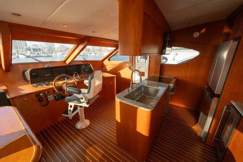Slide: The Image of Interior of 2001 Mikelson 61 Yachtfisher with helm, kitchen, and wooden flooring. - 80