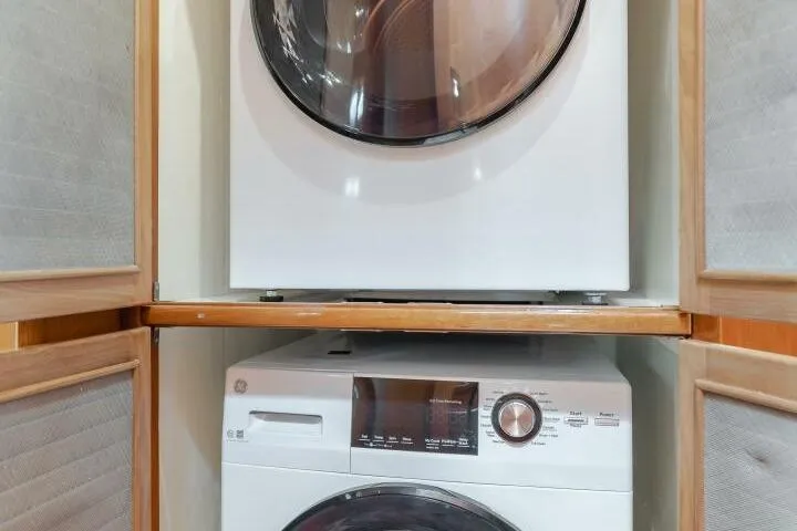 Slide: The Image of Stacked washer and dryer inside 2001 Mikelson 61 Yachtfisher. - 81