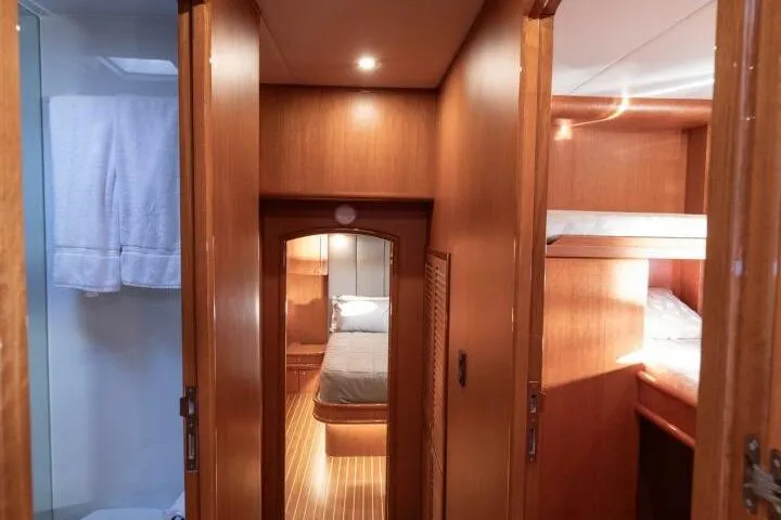 Slide: The Image of Luxurious interior of 2001 Mikelson 61 Yachtfisher, featuring cozy wooden cabin and bunk beds. - 82