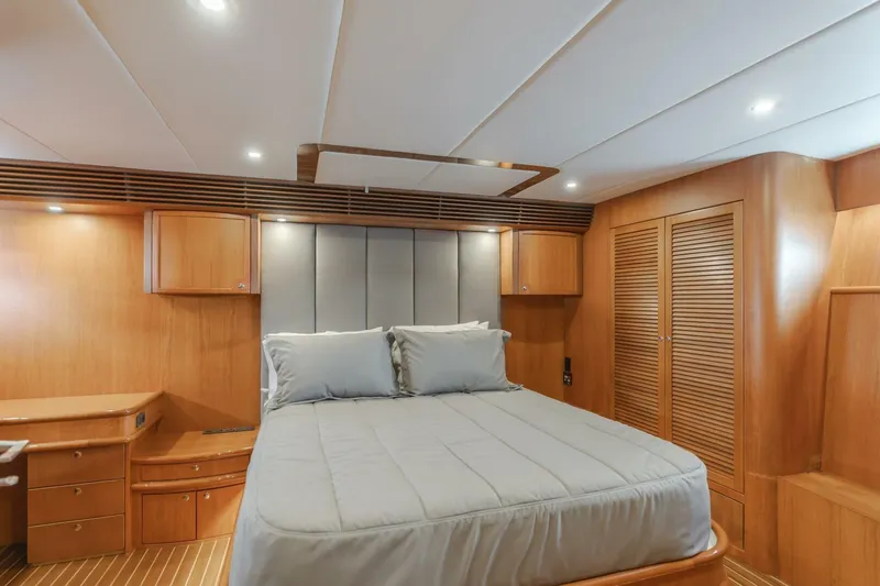Slide: The Image of Luxurious bedroom interior of 2001 Mikelson 61 Yachtfisher with wood paneling and cozy bedding. - 83