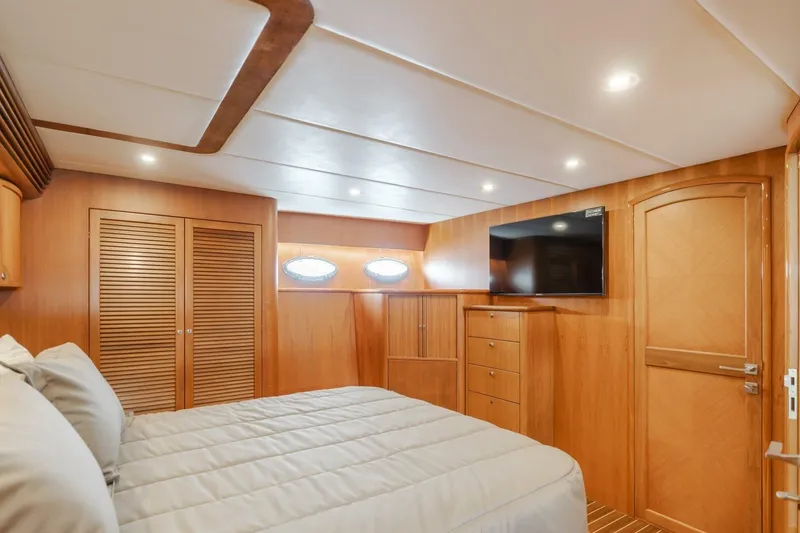 Slide: The Image of Luxurious cabin interior of 2001 Mikelson 61 Yachtfisher with wood paneling and modern amenities. - 84