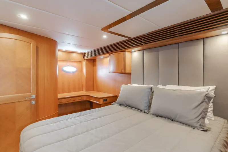 Slide: The Image of Luxurious bedroom interior of 2001 Mikelson 61 Yachtfisher with elegant wood finishes and cozy bedding. - 85