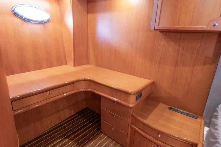 Slide: The Image of Luxurious wooden interior of a 2001 Mikelson 61 Yachtfisher, featuring a built-in desk and drawers. - 87
