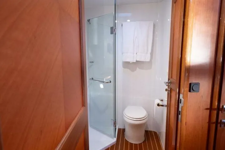 Slide: The Image of Luxurious bathroom in 2001 Mikelson 61 Yachtfisher with glass shower and wooden accents. - 88
