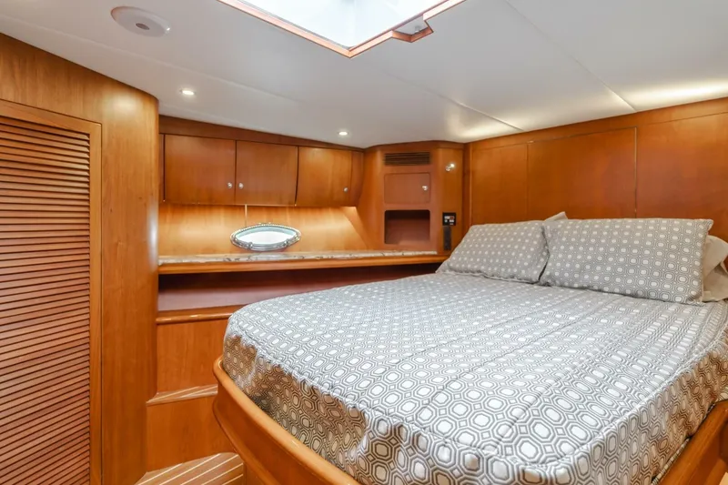 Slide: The Image of Luxurious cabin interior of 2001 Mikelson 61 Yachtfisher with wood paneling and cozy bedding. - 95