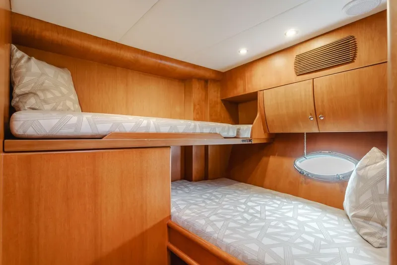 Slide: The Image of Interior of 2001 Mikelson 61 Yachtfisher with wooden bunk beds and modern lighting. - 98