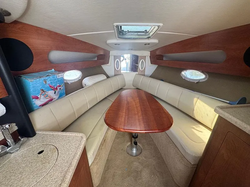 Slide: The Image of 2008 Rinker 280 Express Cruiser cabin interior with seating and table. - 12