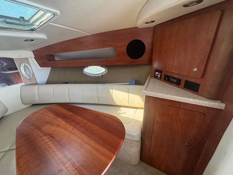 Slide: The Image of Interior of 2008 Rinker 280 Express Cruiser with wood accents and seating area. - 13