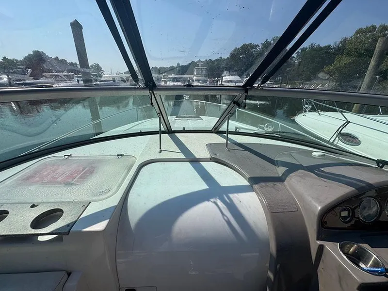 Slide: The Image of 2008 Rinker 280 Express Cruiser cockpit view with marina background. - 15