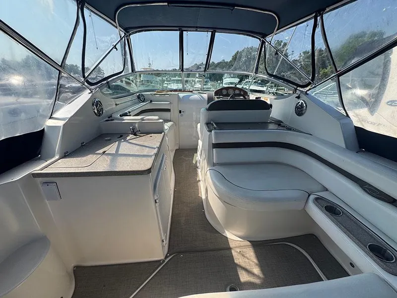 Slide: The Image of 2008 Rinker 280 Express Cruiser interior with seating, helm, and kitchenette. - 17