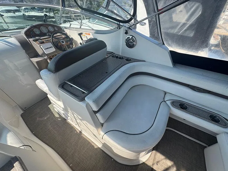 Slide: The Image of 2008 Rinker 280 Express Cruiser interior with helm, seating, and dashboard controls. - 19