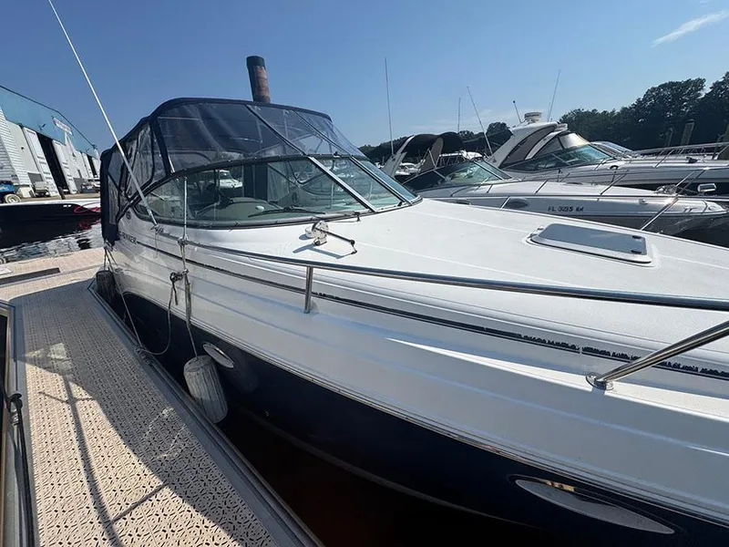 Slide: The Image of 2008 Rinker 280 Express Cruiser docked at marina under clear blue sky. - 3
