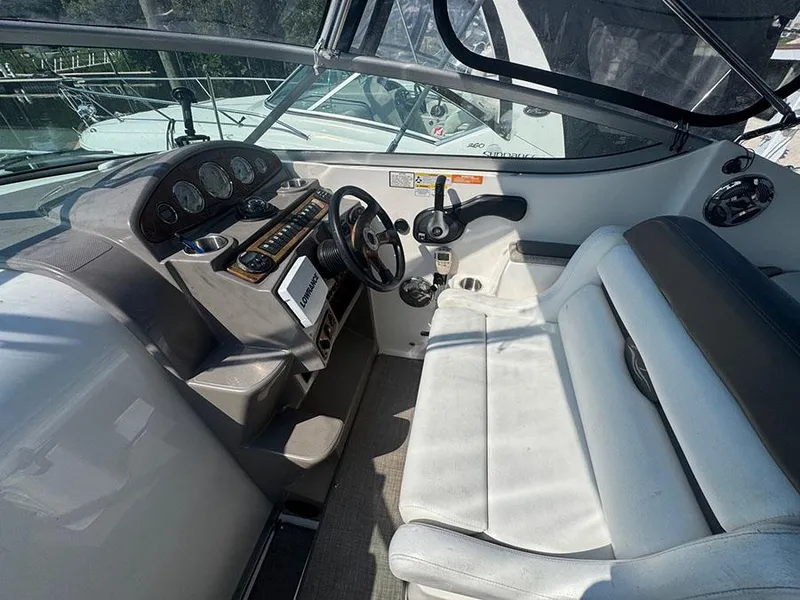 Slide: The Image of 2008 Rinker 280 Express Cruiser cockpit with steering wheel and seating. - 5