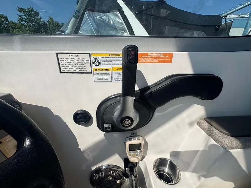 Slide: The Image of 2008 Rinker 280 Express Cruiser helm controls with warning labels and communication device. - 7
