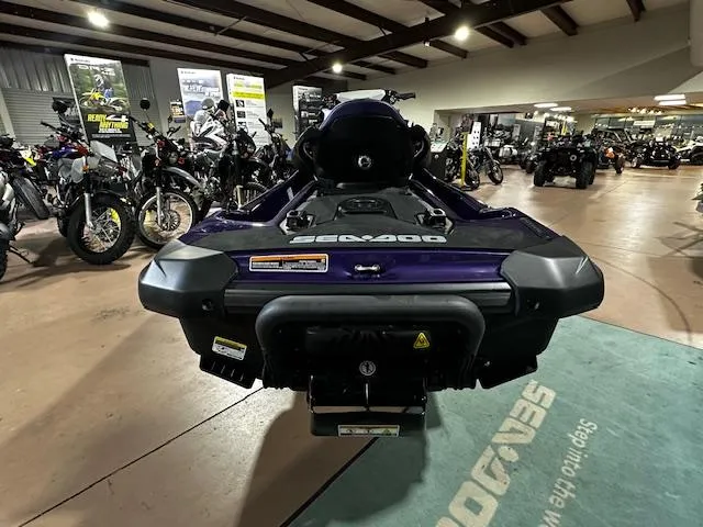 Slide: The Image of 2025 Sea-Doo GTI SE 130 W/ Audio, displayed in a showroom with motorcycles. - 10