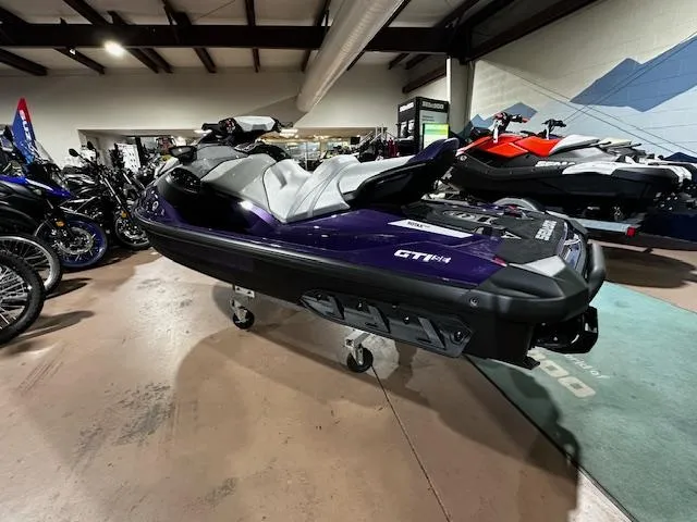 Slide: The Image of 2025 Sea-Doo GTI SE 130 with Audio, displayed in showroom, side view. - 8