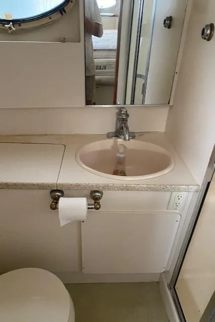 Slide: The Image of Bathroom interior of 1999 Silverton 392 Motor Yacht with sink and mirror. - 14