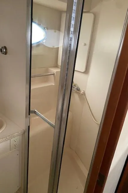 Slide: The Image of Bathroom interior of 1999 Silverton 392 Motor Yacht with shower and porthole window. - 15