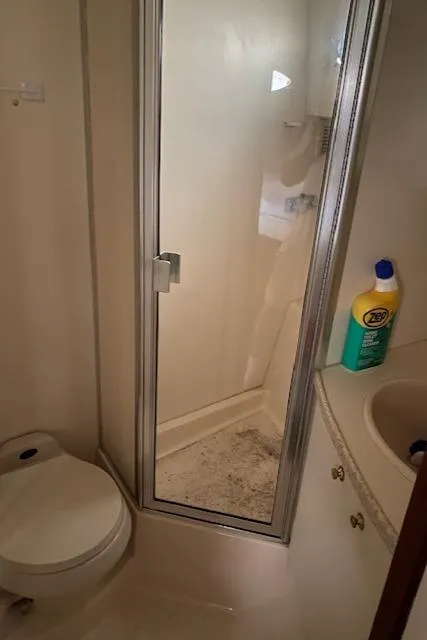 Slide: The Image of Bathroom in 1999 Silverton 392 Motor Yacht with shower, toilet, and cleaning supplies. - 17