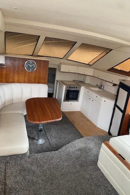 Slide: The Image of Interior of 1999 Silverton 392 Motor Yacht with kitchen, seating, and clock. - 8