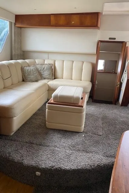 Slide: The Image of Interior of 1999 Silverton 392 Motor Yacht with beige seating and carpet. - 9