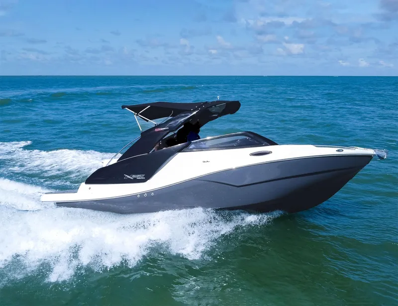 Slide: The Image of 2025 NX Boats NX260 EVOLUTION cruising on open sea under clear skies. - 1