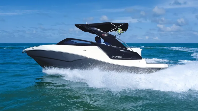 Slide: The Image of 2025 NX Boats NX260 EVOLUTION cruising on blue ocean waves under clear skies. - 5