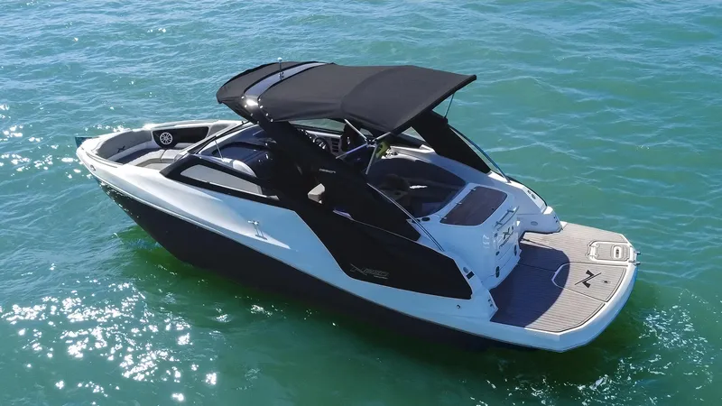 Slide: The Image of 2025 NX Boats NX260 EVOLUTION on water, sleek design, black canopy, modern features. - 6